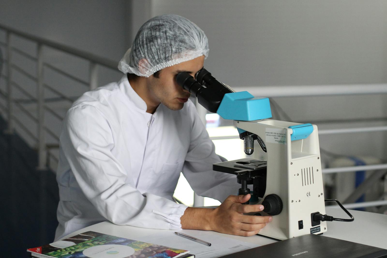 Our Services 7 Scientist in a lab coat using a microscope to conduct research, focusing on healthcare improvements.