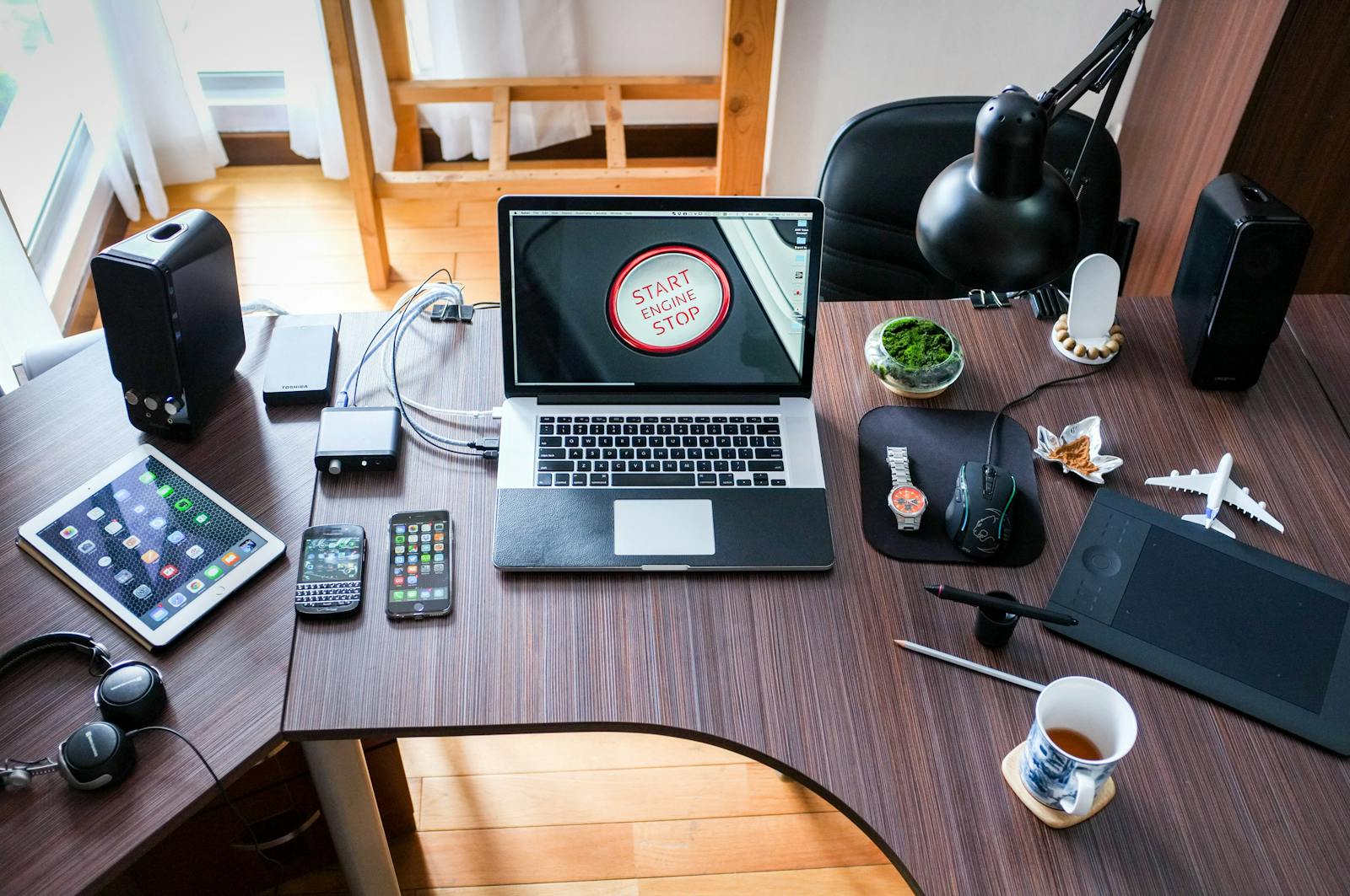 Our Services 4 A contemporary office desk setup with laptops, gadgets, and accessories, creating a tech-savvy workplace.
